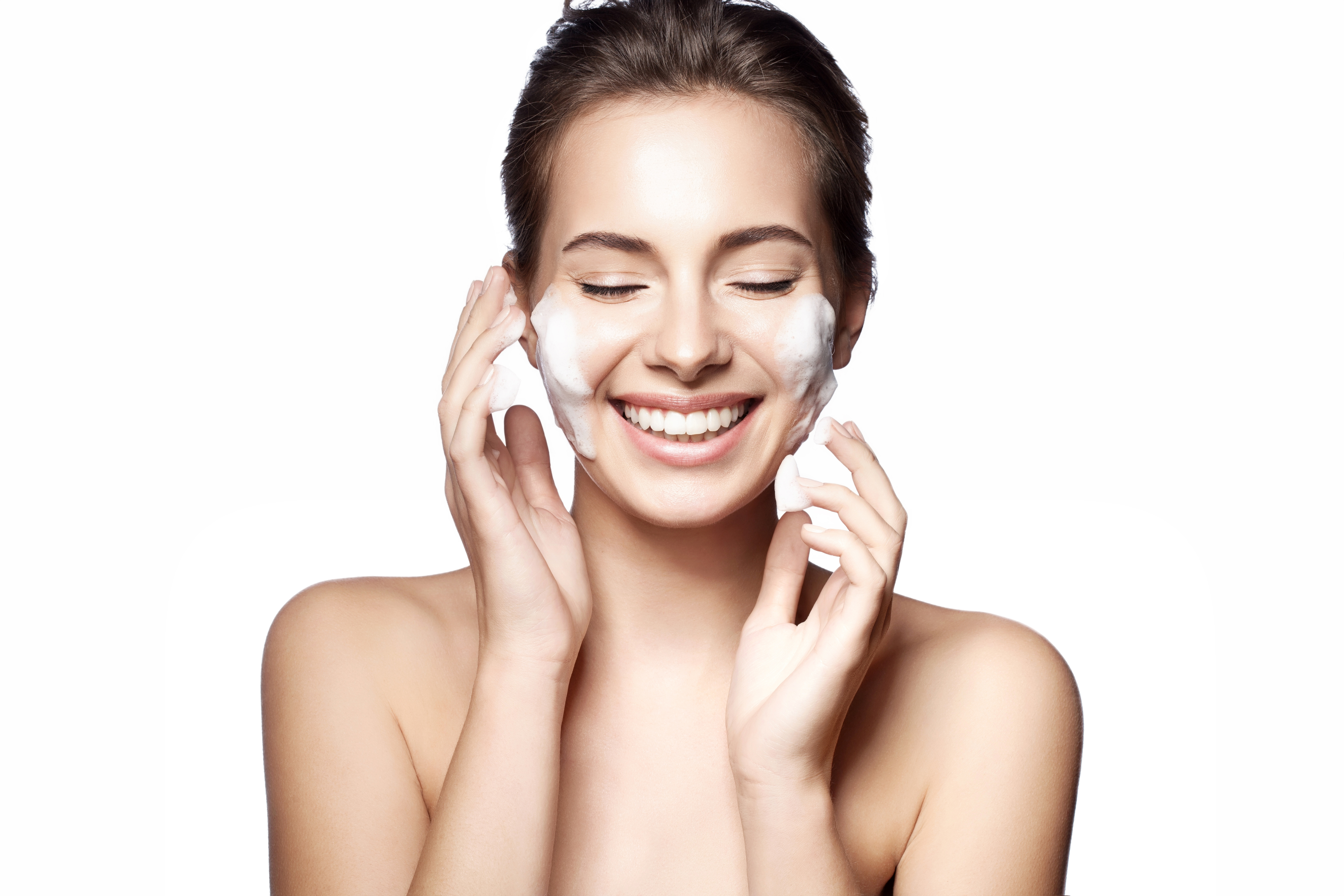 a woman using facial wash