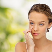 A girl applying eye cream