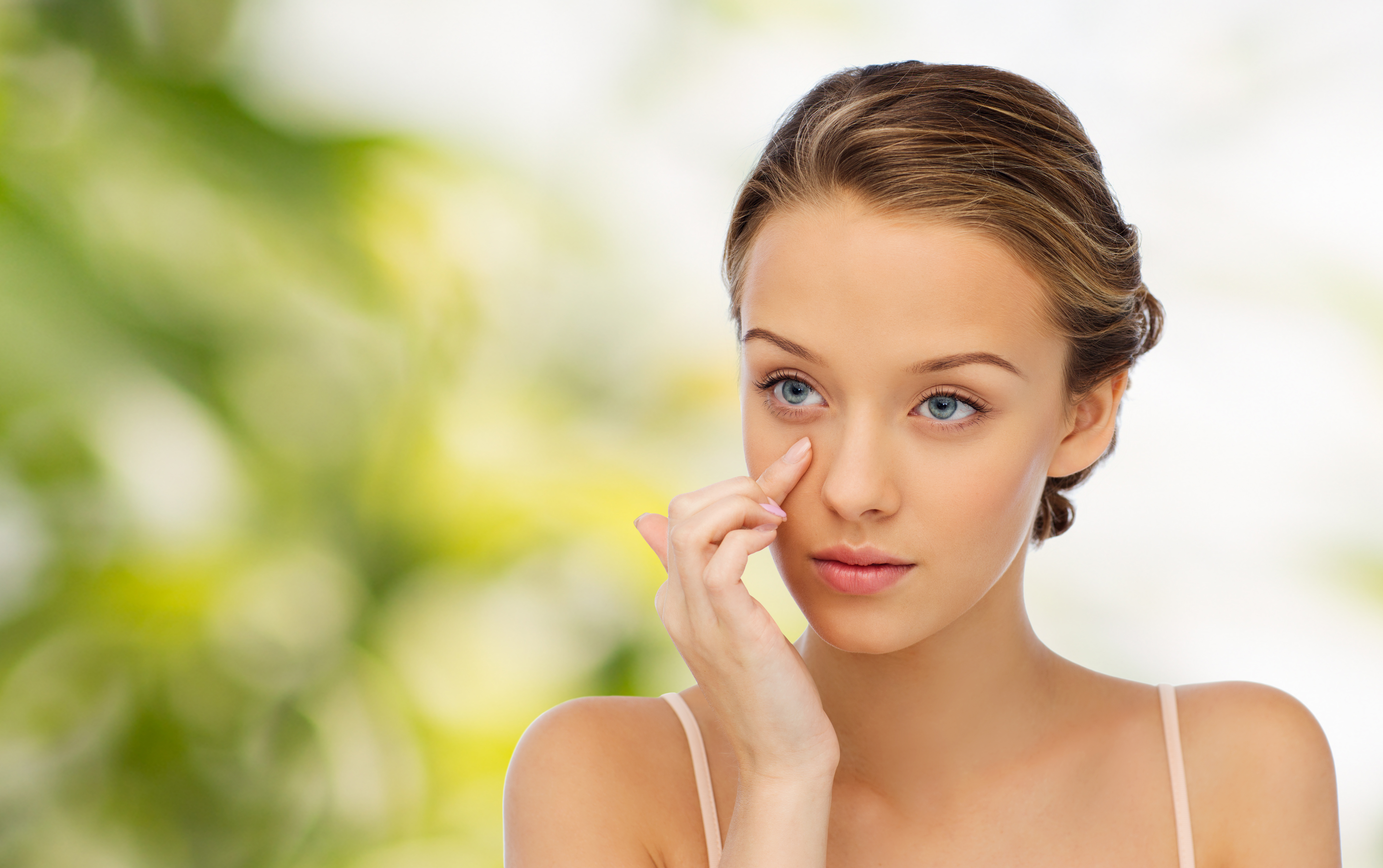 A girl applying eye cream